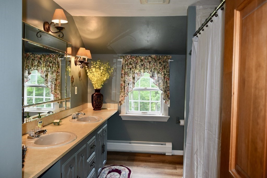 62 West Branch Road Ashfield, MA 01330 - Photo 39 of 42 a bathroom with a granite countertop sink mirror vanity and a bathtub