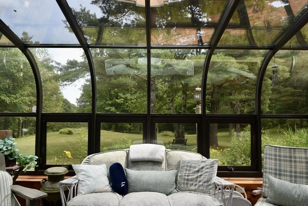 62 West Branch Road Ashfield, MA 01330 - Photo 6 of 42 a living room with large windows and a table
