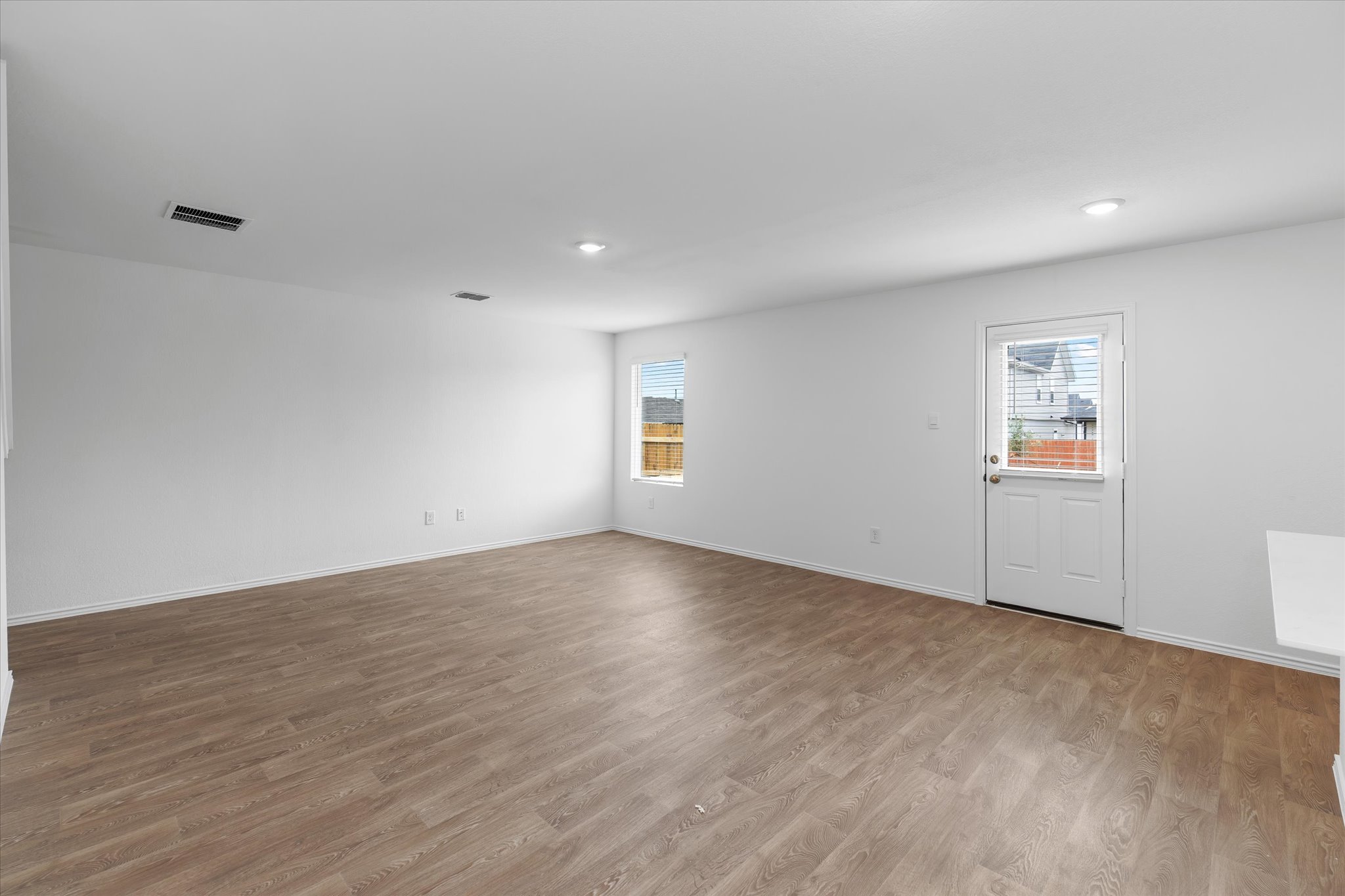 456 Sandringham Loop Kyle, TX 78640 - Photo 29 of 40 An airy living area offers durable laminate flooring and direct outdoor access.