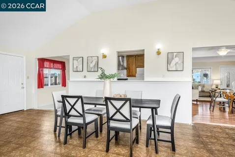 a dining room with furniture and wooden floor