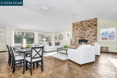 a living room with furniture a fireplace and a table