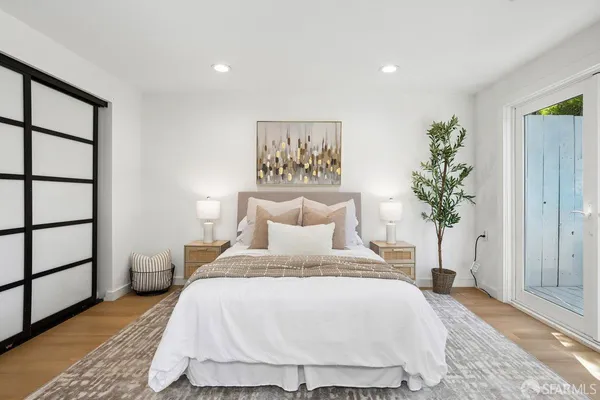 a bed sitting in a bedroom next to a window