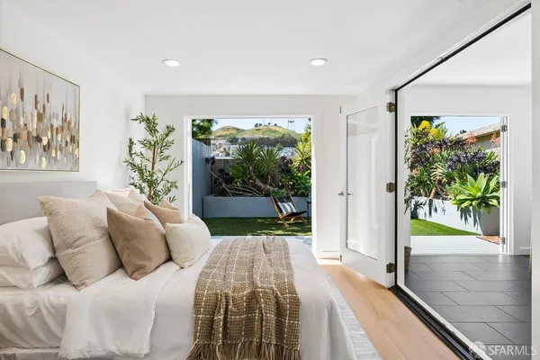 a bedroom with a large bed and a couch