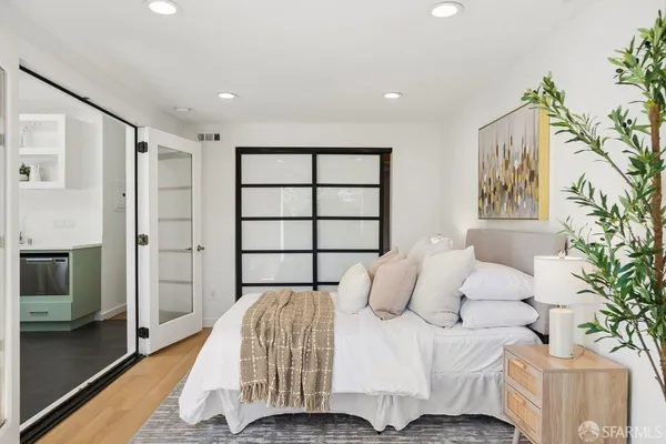 a spacious bedroom with a bed and window