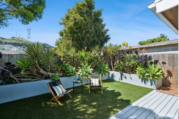 a view of a backyard with plants and a patio