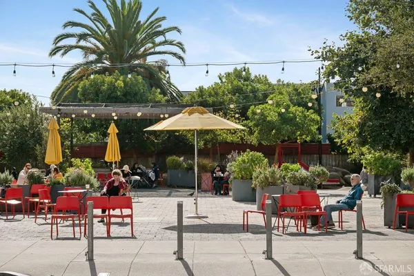 a view of a chairs and umbrellas in front of building