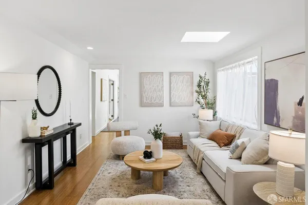 a living room with furniture a rug and a window