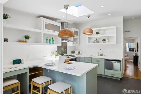 a kitchen with a table chairs stove and microwave