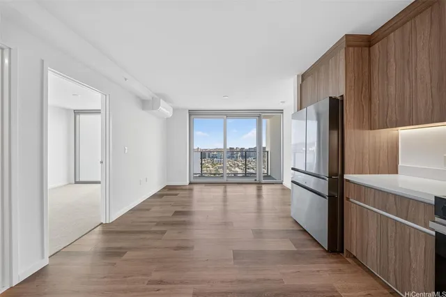 a view of a kitchen with a refrigerator a microwave and a sink