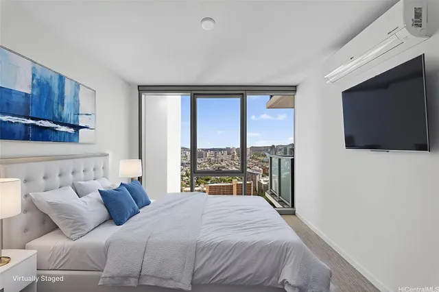 a bedroom with a large bed and a flat tv screen on dresser