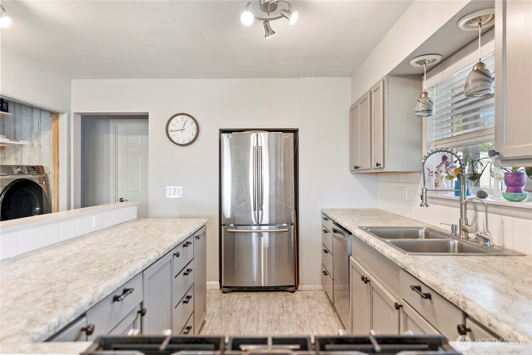 519 Locust Street Omak, WA 98841 - Photo 14 of 33 a kitchen with kitchen island granite countertop a sink stove and refrigerator