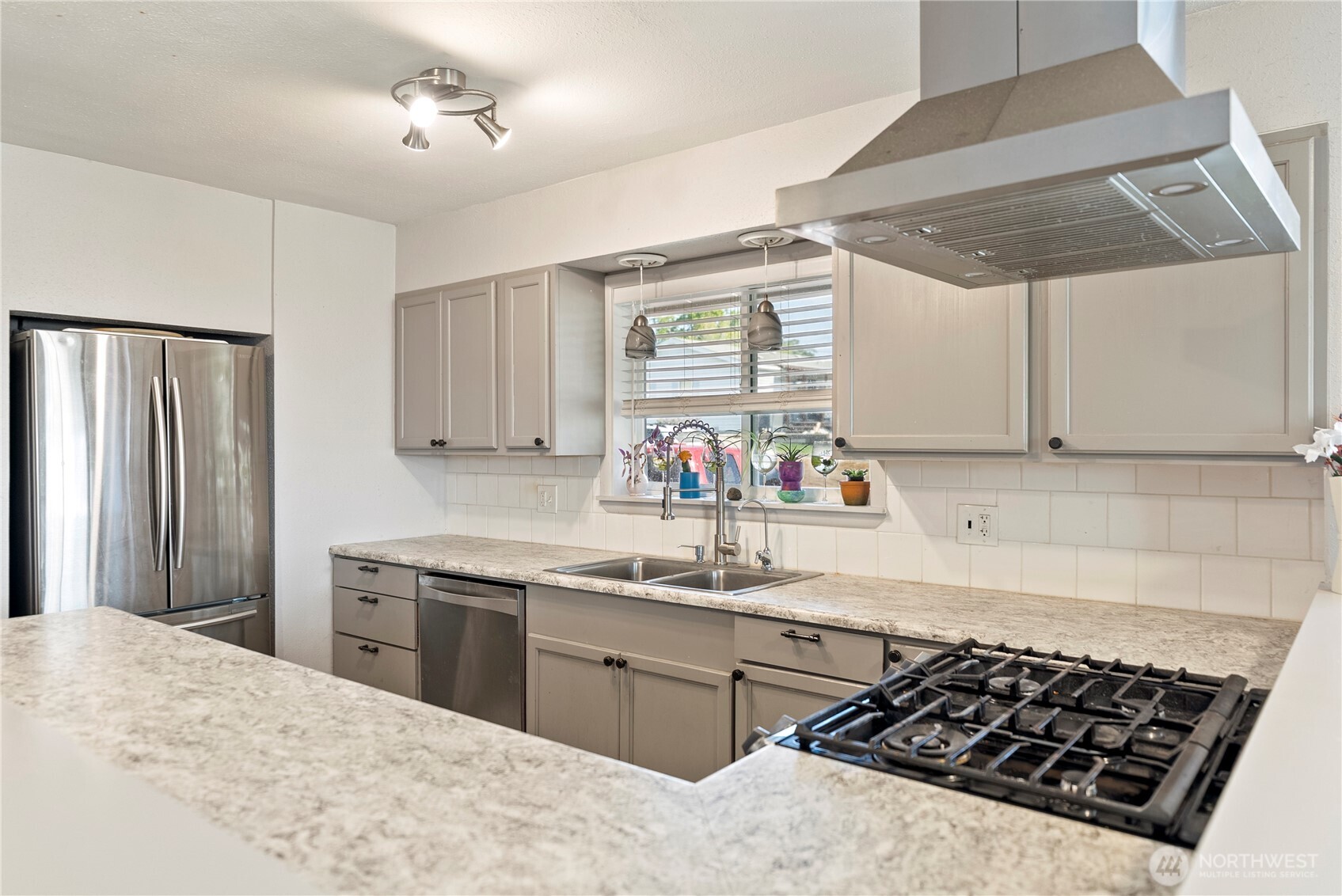 519 Locust Street Omak, WA 98841 - Photo 16 of 33 a kitchen with stainless steel appliances a sink stove and refrigerator