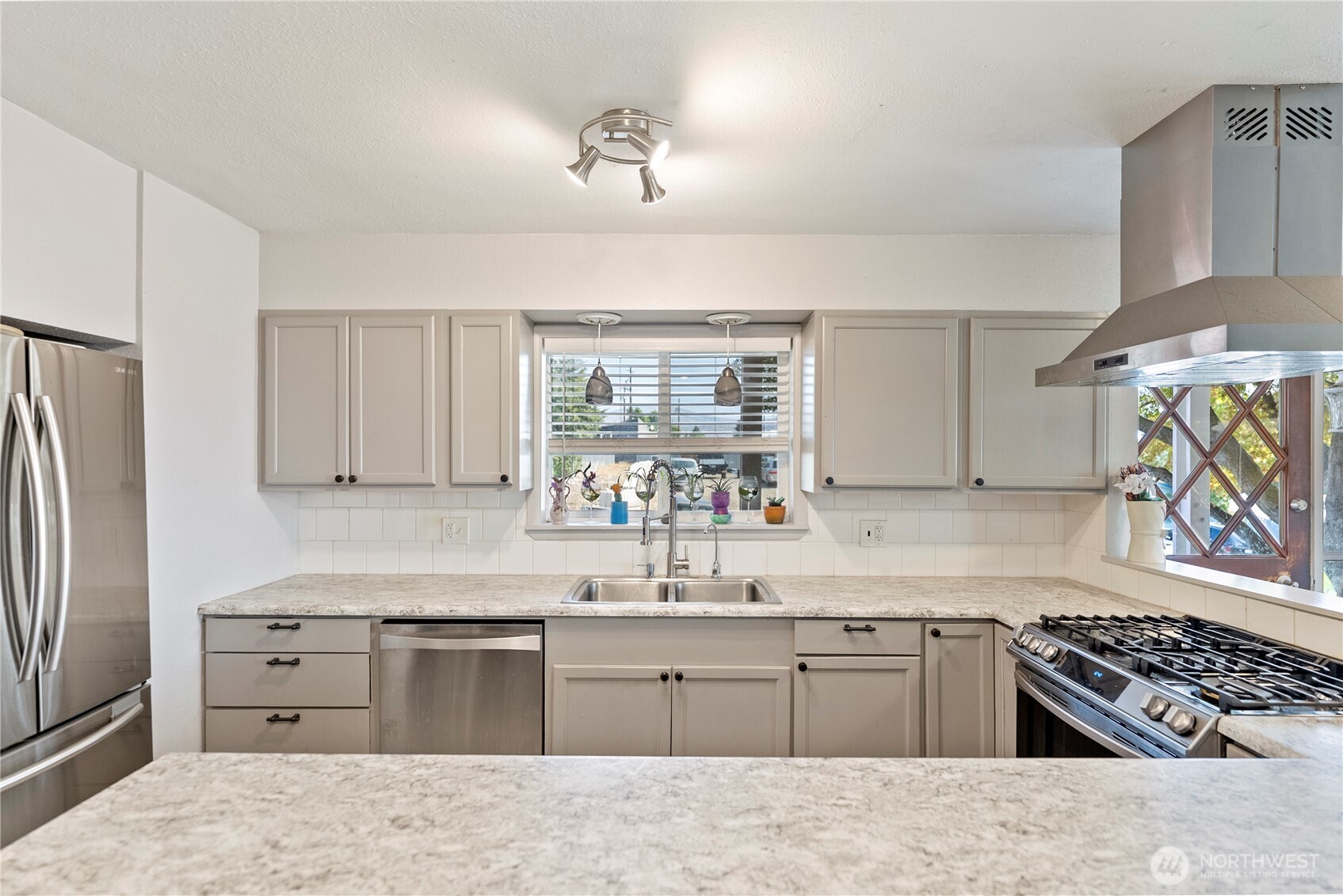 519 Locust Street Omak, WA 98841 - Photo 17 of 33 a kitchen with granite countertop a sink stainless steel appliances and window