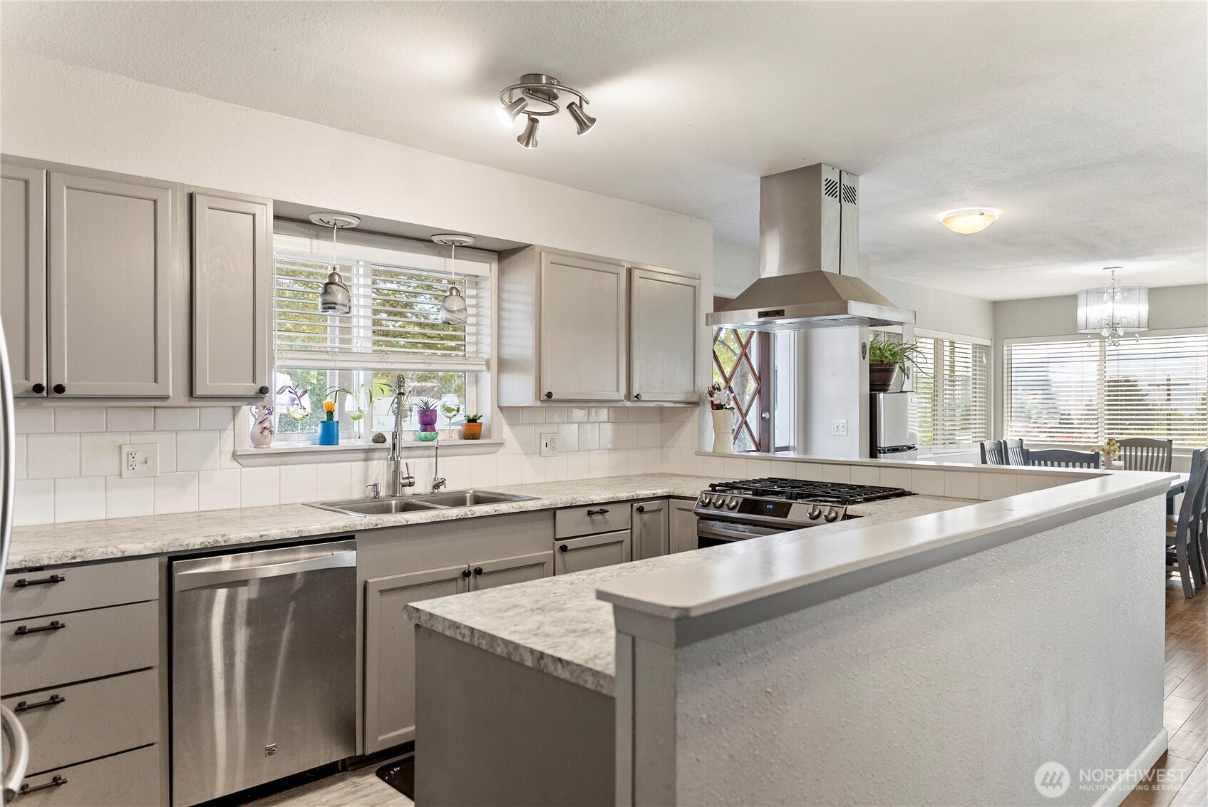 519 Locust Street Omak, WA 98841 - Photo 18 of 33 a kitchen with stainless steel appliances granite countertop a sink a stove a refrigerator and island