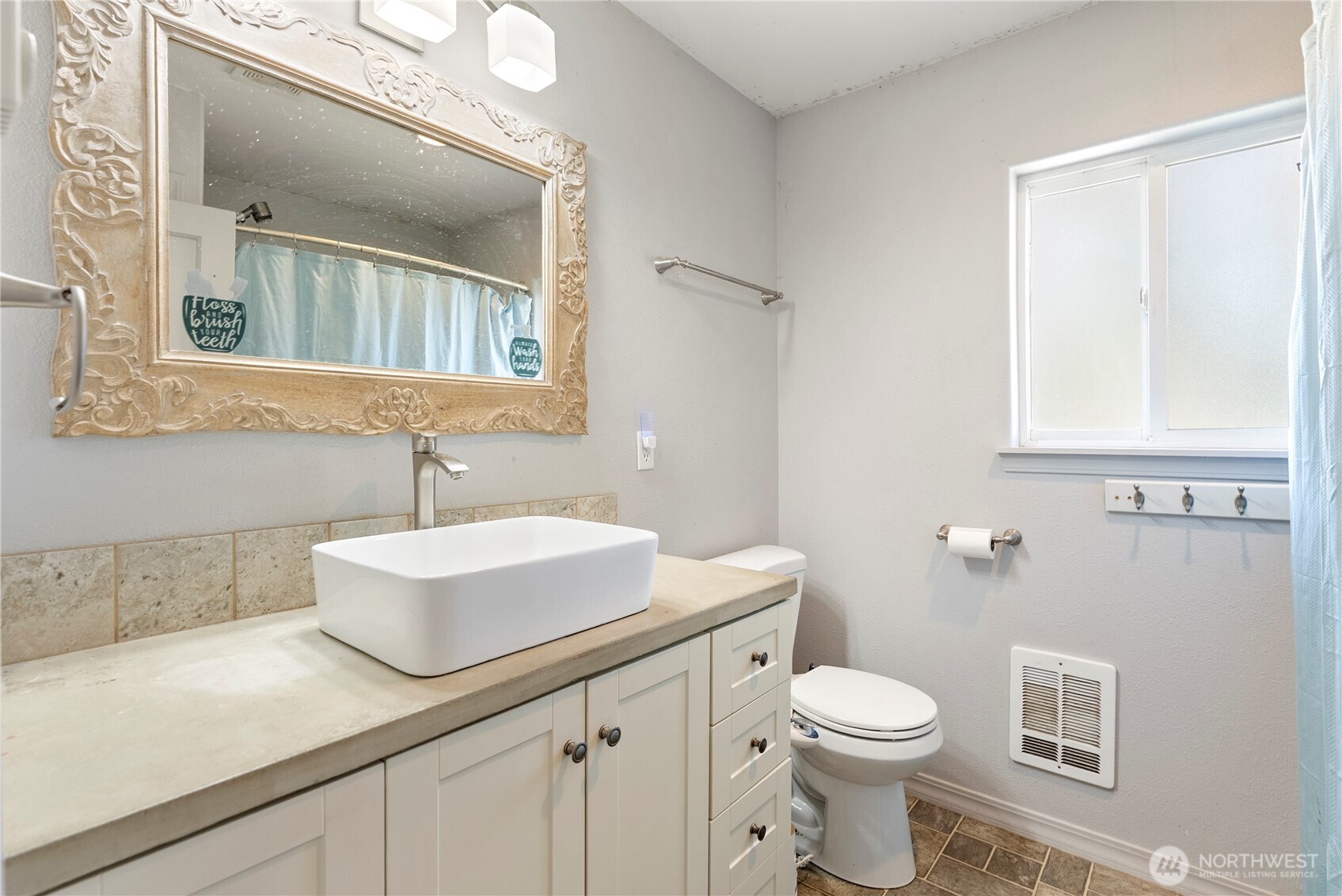 519 Locust Street Omak, WA 98841 - Photo 21 of 33 a bathroom with a sink a toilet and mirror