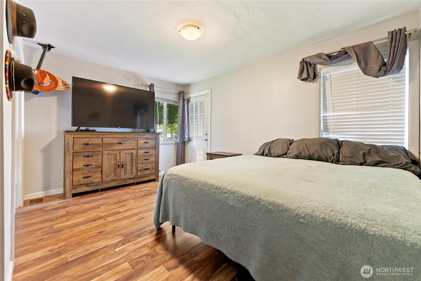 519 Locust Street Omak, WA 98841 - Photo 22 of 33 a bedroom with a bed and a flat screen tv