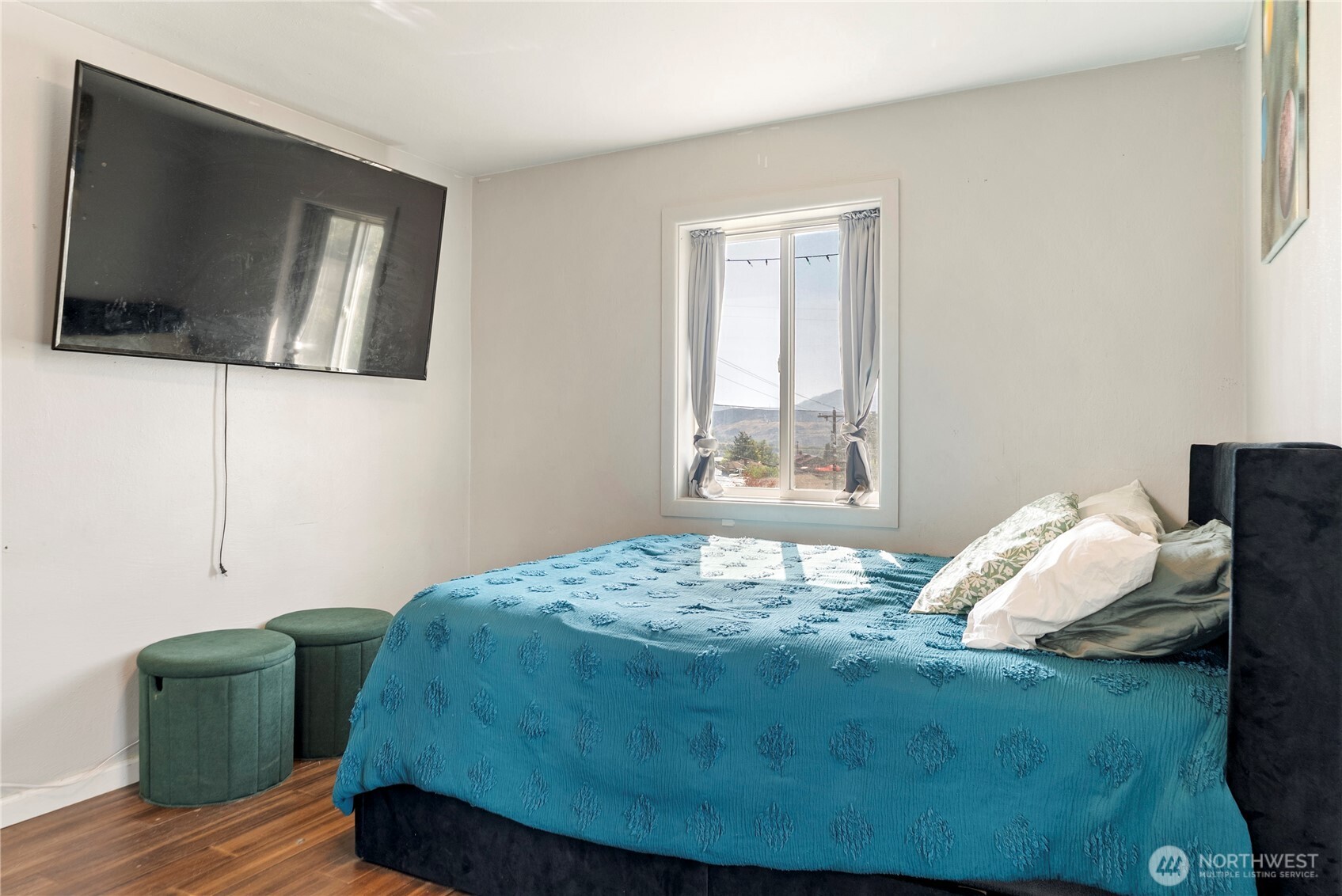 519 Locust Street Omak, WA 98841 - Photo 25 of 33 a bedroom with a bed and wooden floor