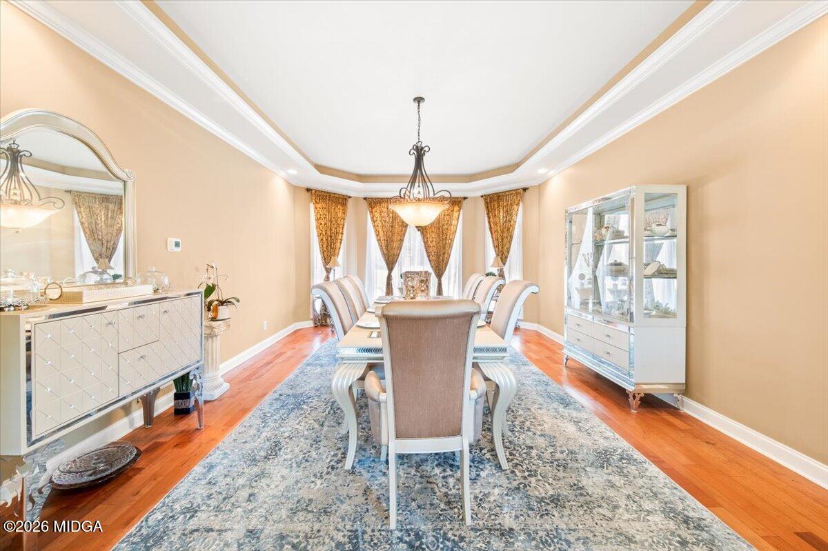 727 Latrobe Way Macon, GA 31220 - Photo 11 of 63 a dining room with chandelier fan and wooden floor