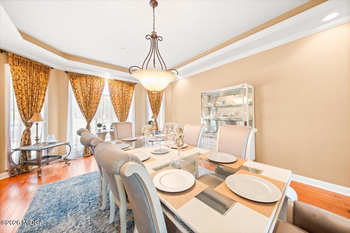 727 Latrobe Way Macon, GA 31220 - Photo 12 of 63 a dining room with furniture a large window and a chandelier
