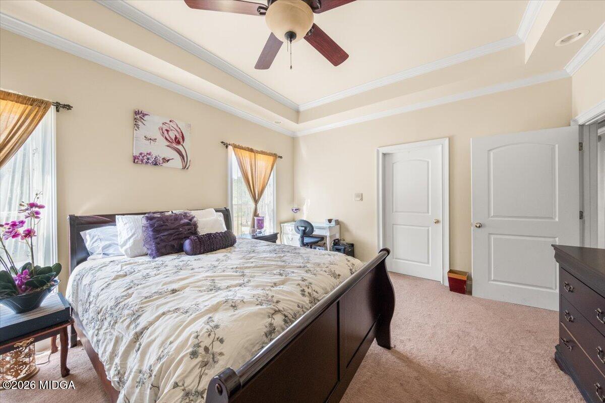 727 Latrobe Way Macon, GA 31220 - Photo 20 of 63 a bedroom with a bed and a chandelier