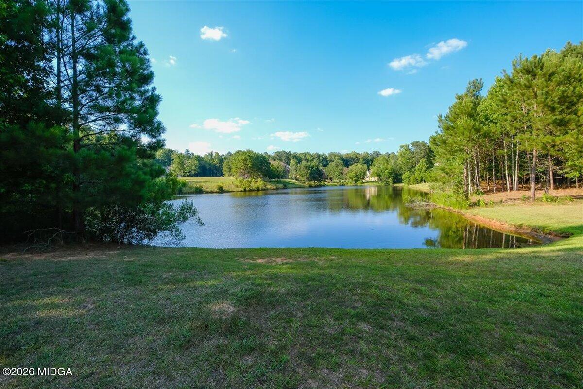 727 Latrobe Way Macon, GA 31220 - Photo 2 of 63 a view of a lake with houses in the back