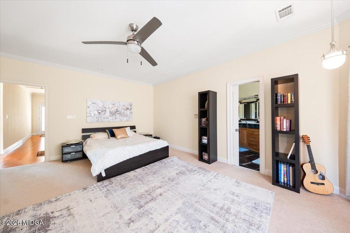 727 Latrobe Way Macon, GA 31220 - Photo 25 of 63 a bedroom with a bed and a large mirror