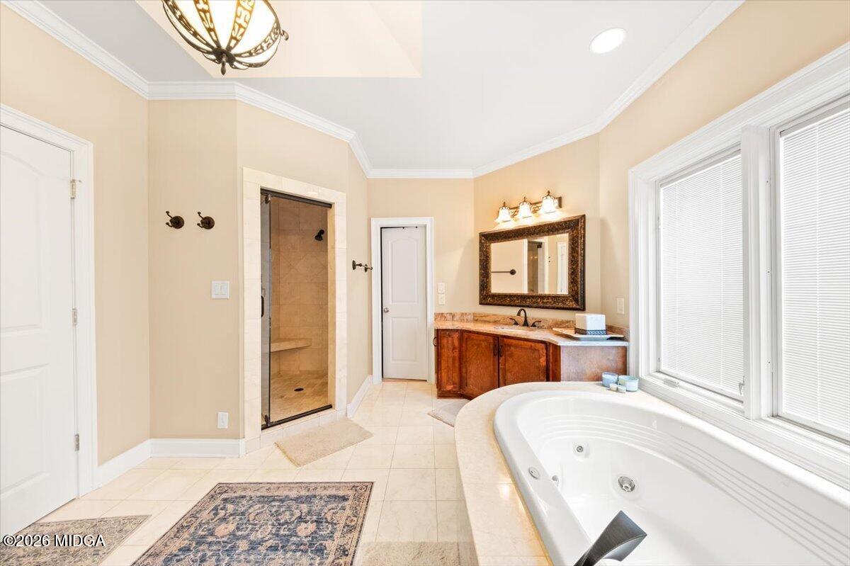 727 Latrobe Way Macon, GA 31220 - Photo 34 of 63 a spacious bedroom with a bed and a chandelier