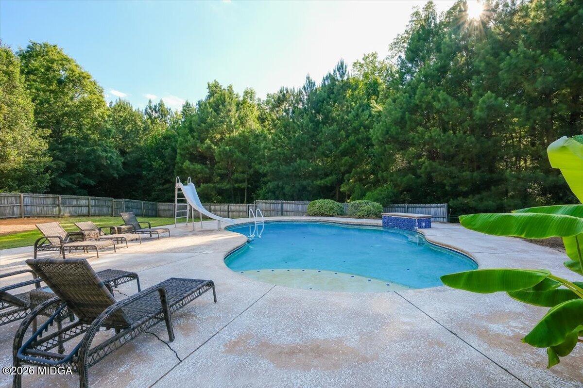 727 Latrobe Way Macon, GA 31220 - Photo 62 of 63 a view of a swimming pool with a patio and a yard