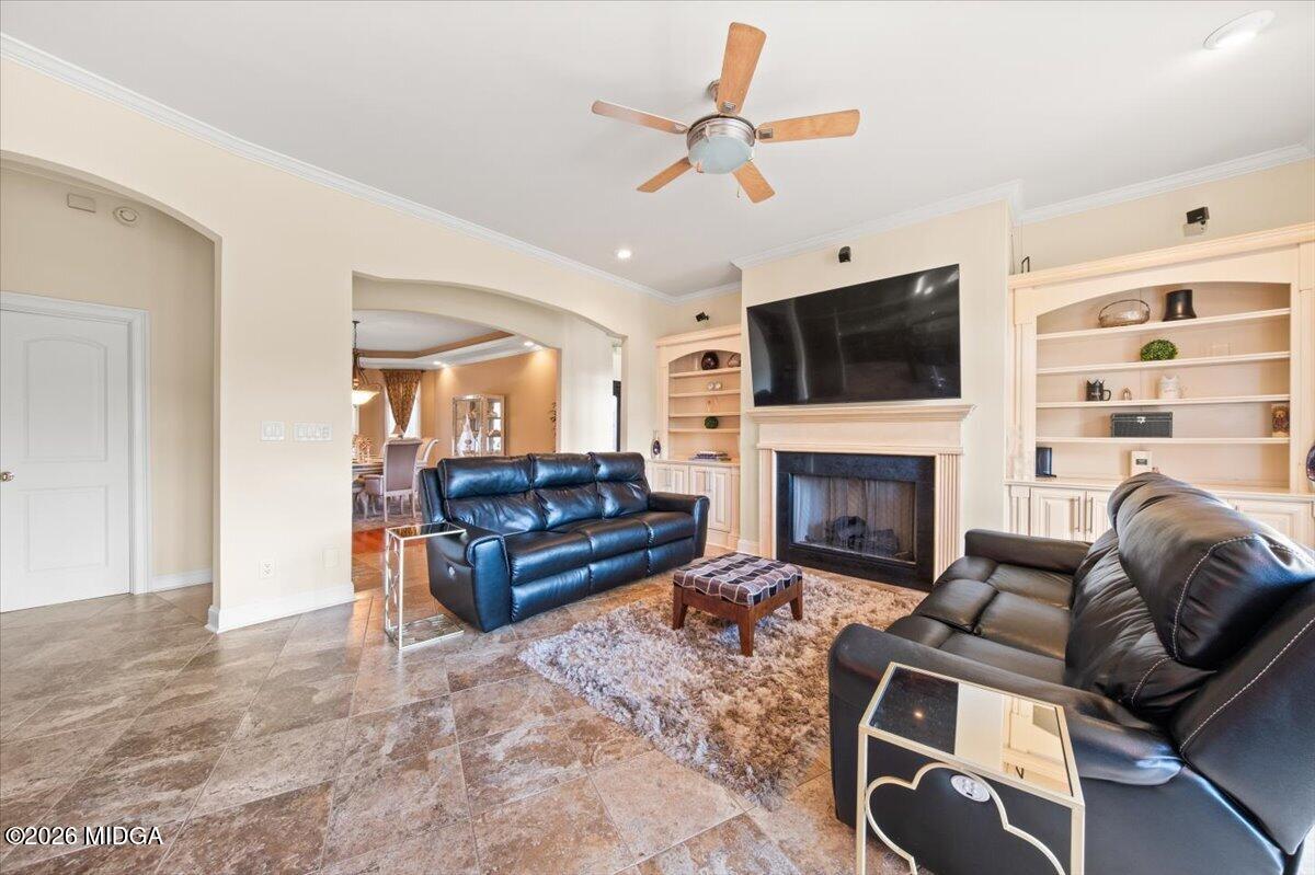727 Latrobe Way Macon, GA 31220 - Photo 10 of 63 a living room with furniture a flat screen tv and a fireplace