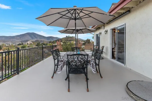 a view of a chairs and table in the balcony
