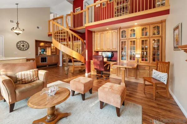 a living room with furniture a fireplace and a rug