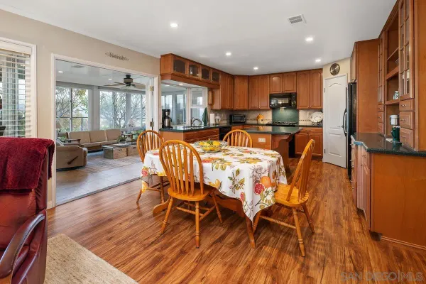 a view of a dining room with furniture window and wooden floor