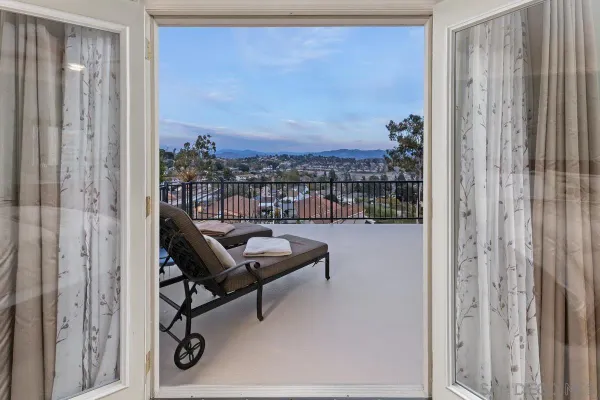 a view of a balcony with chair and floor to ceiling window