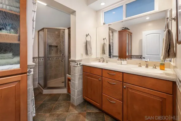 a bathroom with a shower sink and mirror