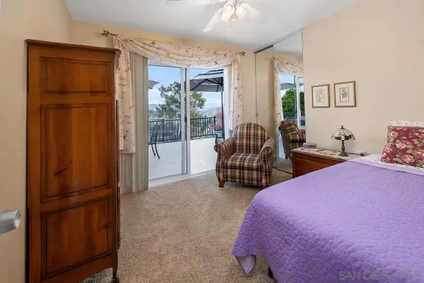 a bedroom with furniture and large windows