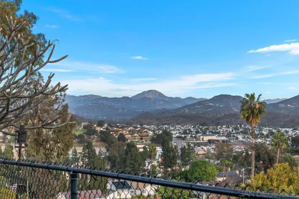 a view of city and mountain from a balcony