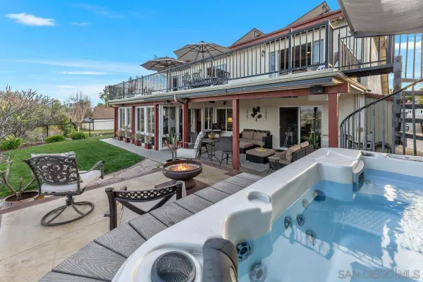 a view of a patio with couches table and chairs and potted plants