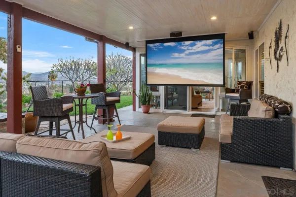 a living room with fireplace furniture and a large window