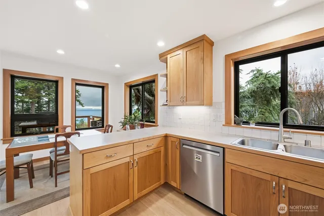a kitchen with a sink and large window