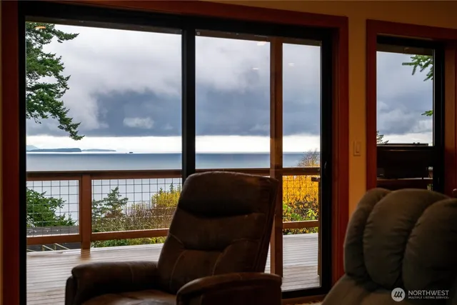 a bedroom with a bed and a dresser next to a window
