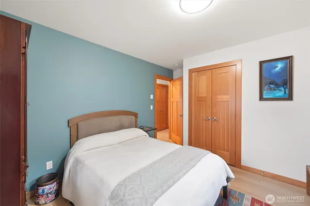 a bedroom with bed and a book shelf