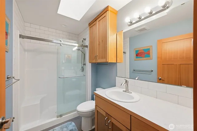 a bathroom with a sink a vanity and a window