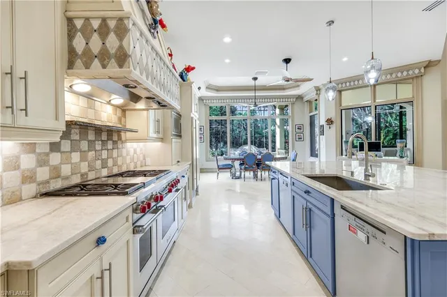 a kitchen with stainless steel appliances granite countertop a sink and a stove