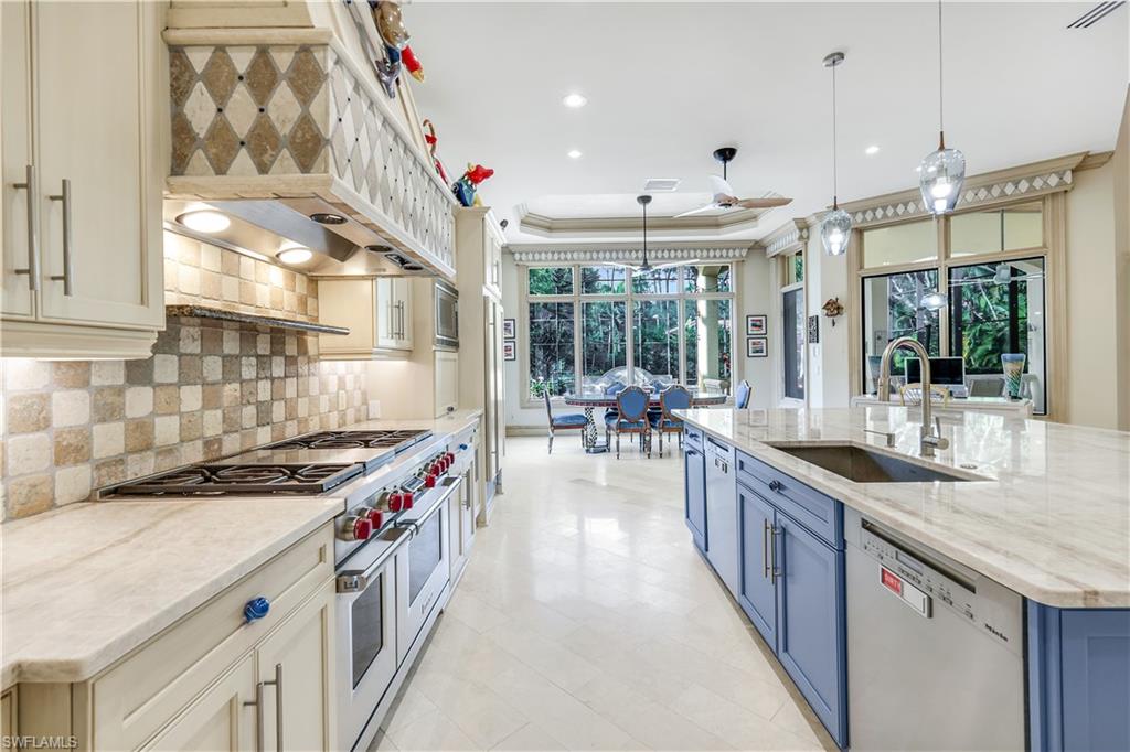 683 Hickory Road Naples, FL 34108 - Photo 11 of 42 a kitchen with stainless steel appliances granite countertop a sink and a stove