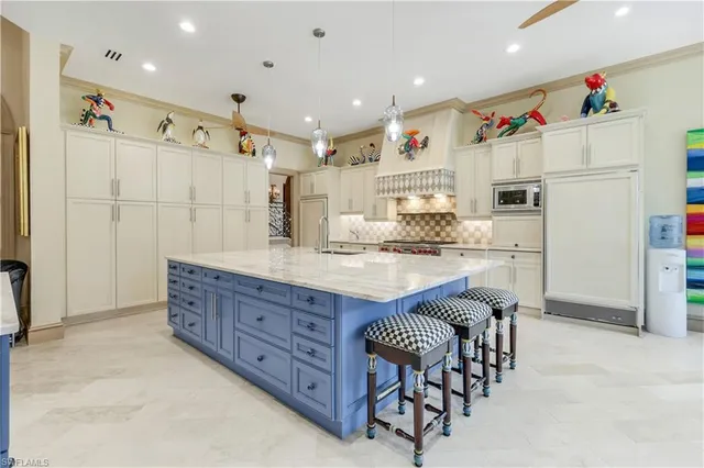 a kitchen with granite countertop a refrigerator and a sink