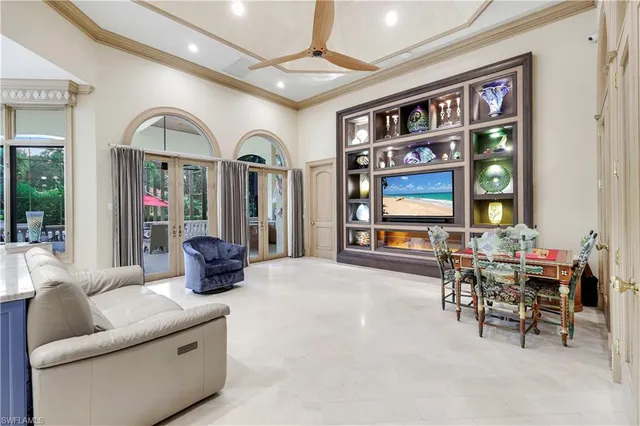 a living room with furniture a window and a flat screen tv