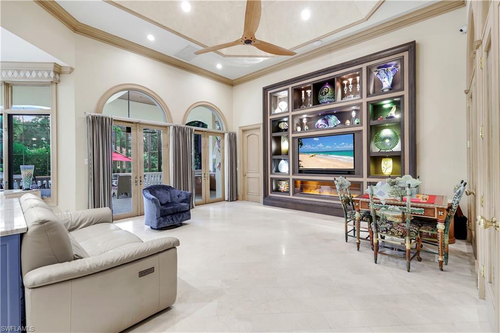 683 Hickory Road Naples, FL 34108 - Photo 14 of 42 a living room with furniture a window and a flat screen tv