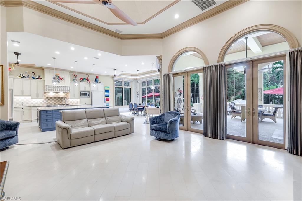 683 Hickory Road Naples, FL 34108 - Photo 15 of 42 a living room with furniture a large window and wooden floors