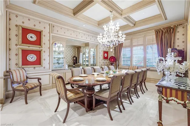 a view of a dining room with furniture and chandelier