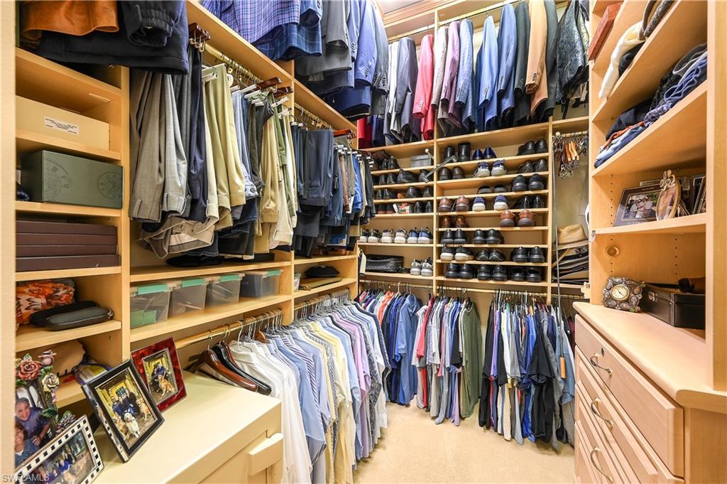 683 Hickory Road Naples, FL 34108 - Photo 22 of 42 a view of walk in closet with clothes and shoes